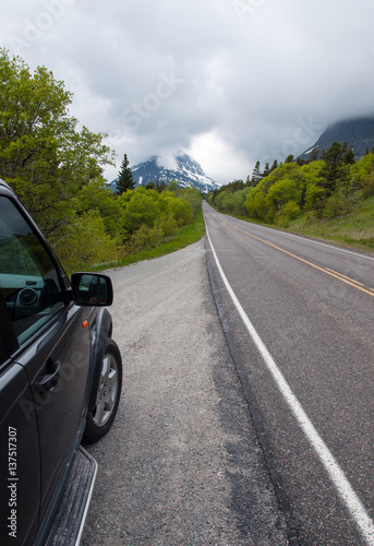 SUV on road by Glacier National Park