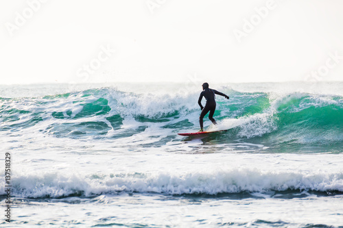 Surfer on blue wave in ocean. Spring surfing © artifirsov