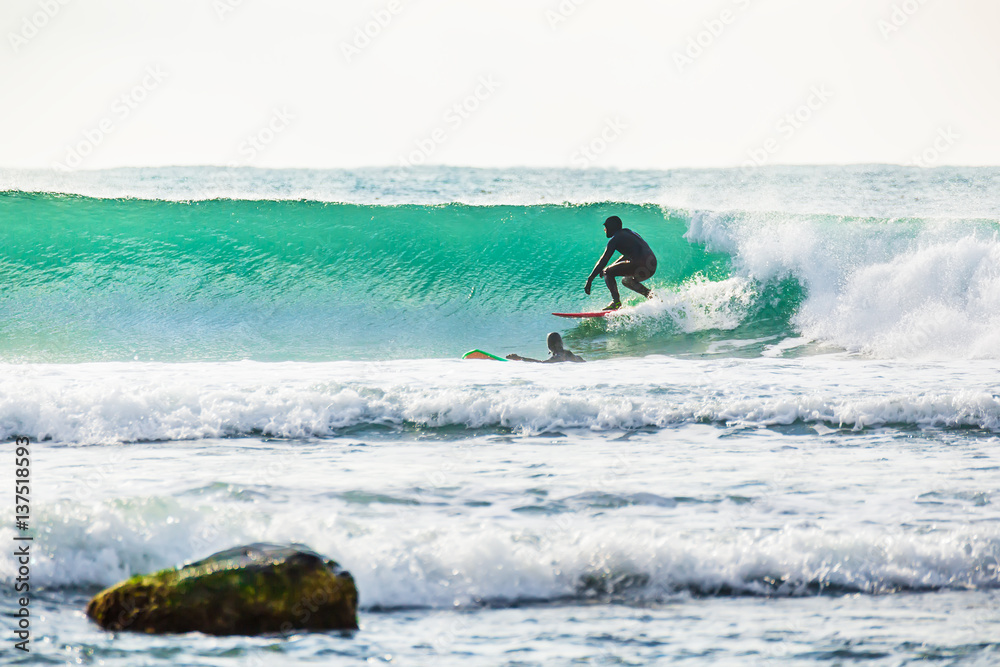 Surfing and turquoise wave in ocean. Sunny day Surfing and turquoise wave in ocean. Sunny day
