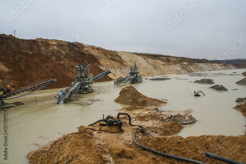 Clay quarry near the town of Pology in the Zaporizhya region of Ukraine flooded heavy rains. Equipment for mining of refractory clay - excavator rotary electric. March 2006