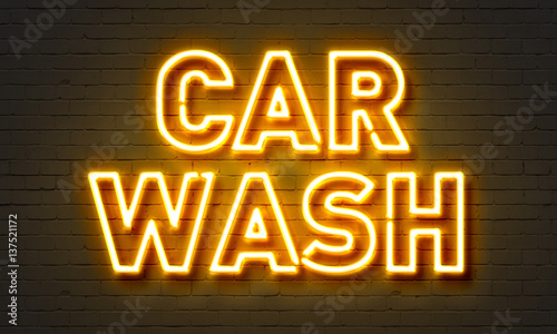 Car wash neon sign on brick wall background. © ibreakstock