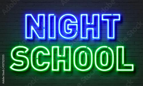 Night school neon sign on brick wall background. photo