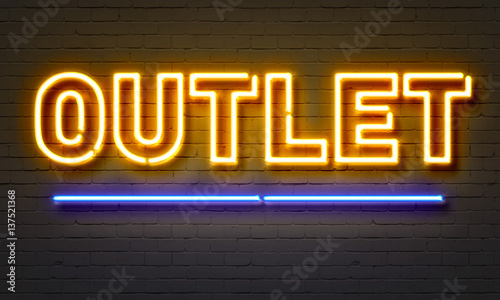 Outlet neon sign on brick wall background. photo