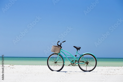 Fototapeta Turquoise bike parked at the beach