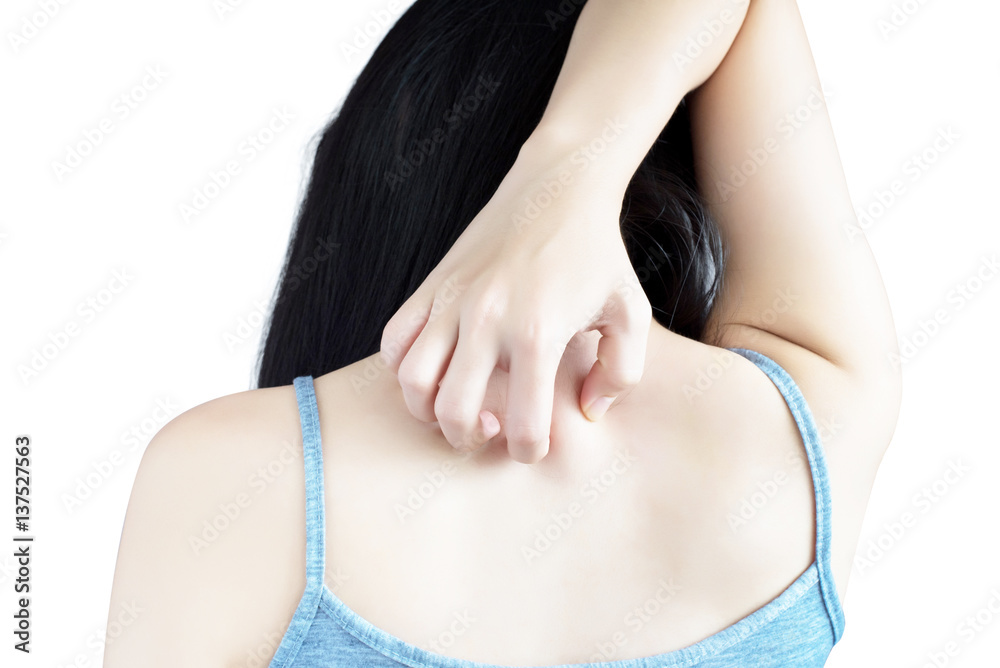 Scratching her back in a woman isolated on white background. Clipping path on white background.