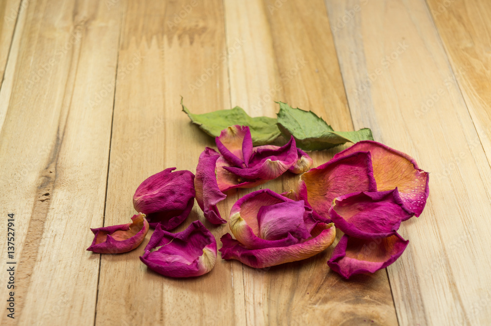 dried rose petals on wood ground