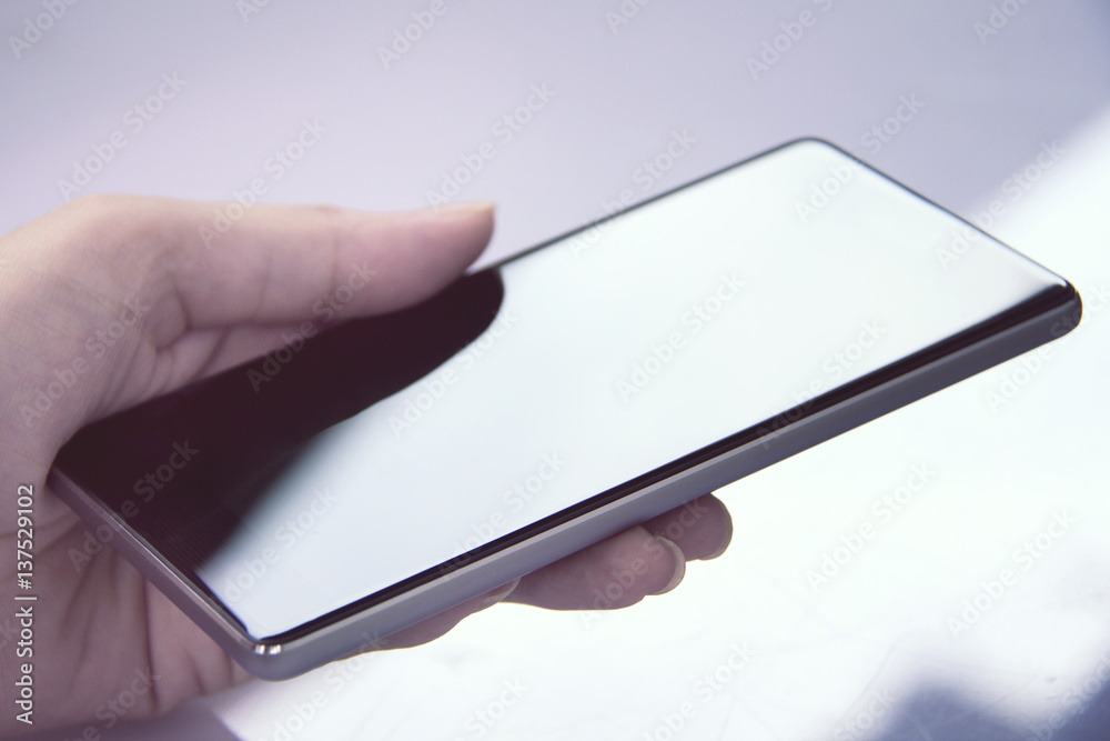 Hand holding mobile smartphone with blank screen Hand holding mobile smartphone with blank screen