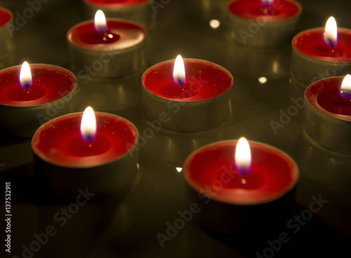Burning candle isolated on black background.