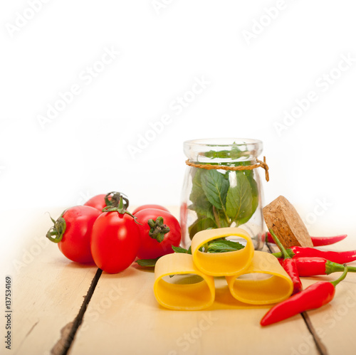 Italian pasta paccheri with tomato mint and chili pepper photo