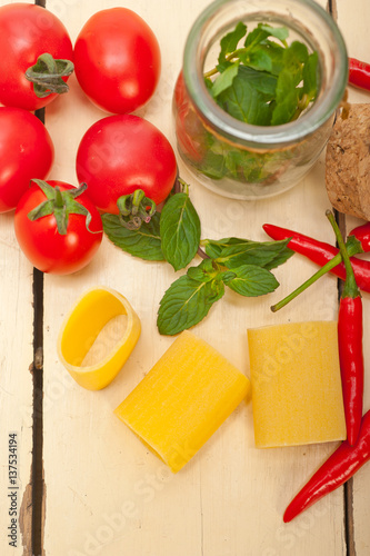 Italian pasta paccheri with tomato mint and chili pepper photo