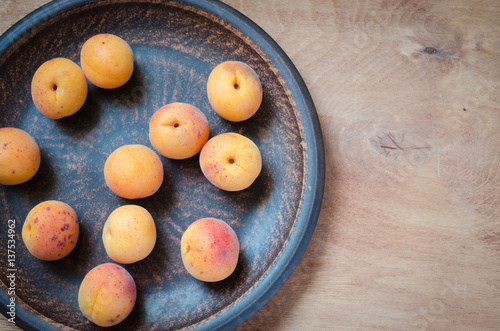 Fresh Organic Apricot in Rustic Plate.