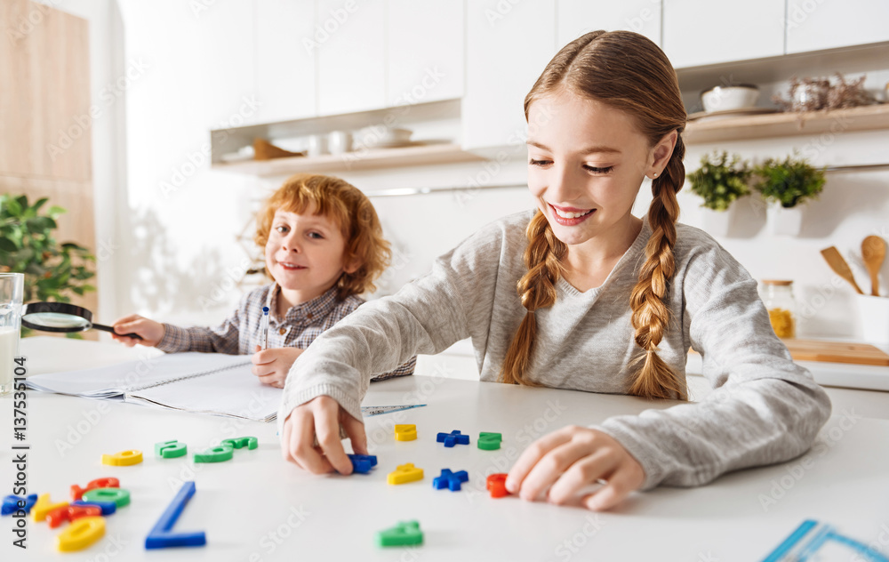 Naklejka premium Bright active children playing in the kitchen
