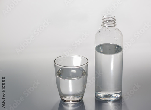 Water, water glass, water bottle, white background.