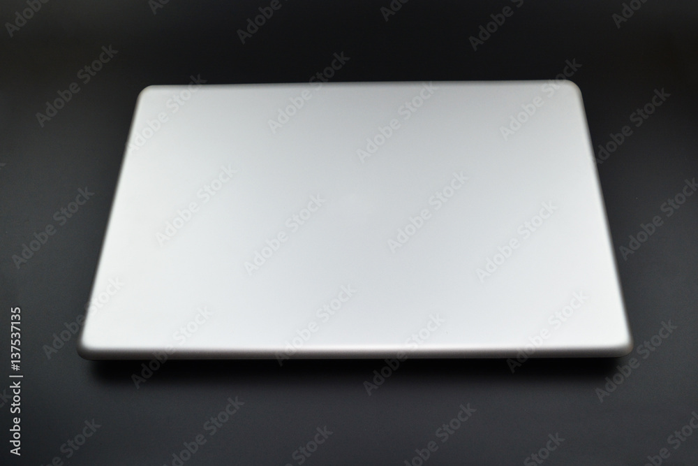 Grey notebook on black background Grey notebook on black background