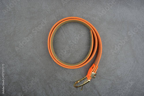 Orange belt on gray background photo