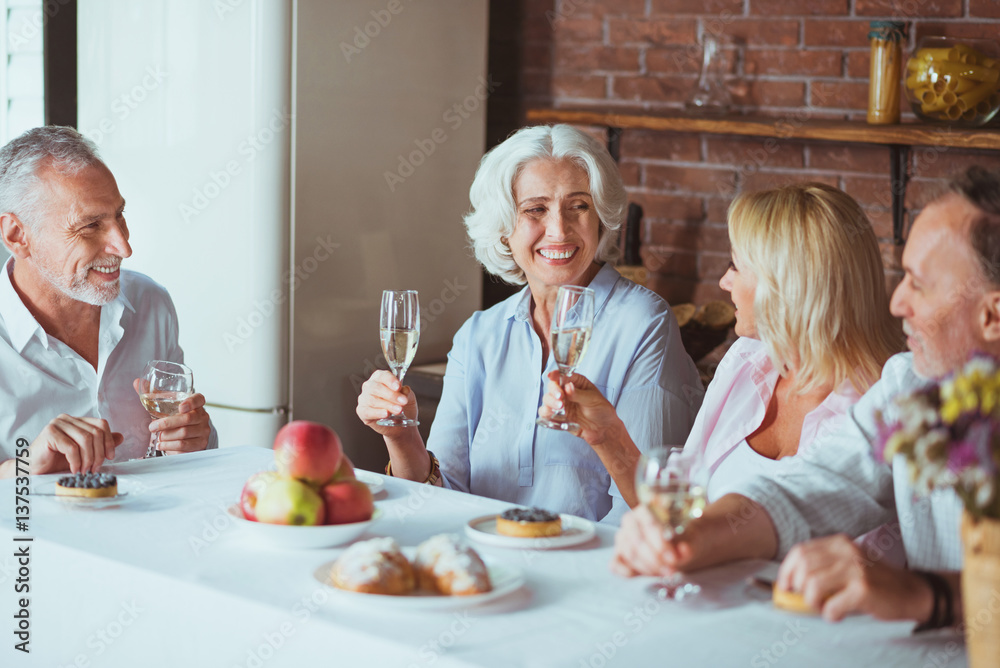 Positive smiling family sitting at the table