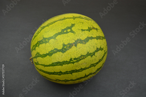 Green watermelon on black background