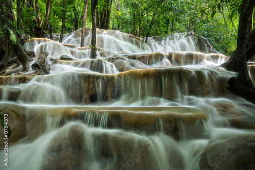 Limestone waterfall in the rainforest, Thailand. © noppharat