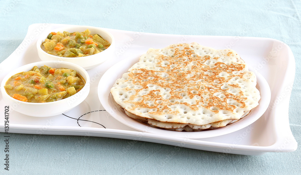Indian food dosa, which is a traditional and popular food, made from rice batter, and vegetable curry.