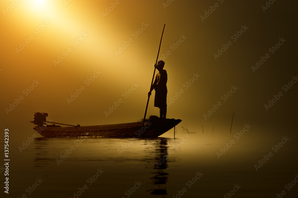 Silhouettes fisherman and sunset, Thailand.