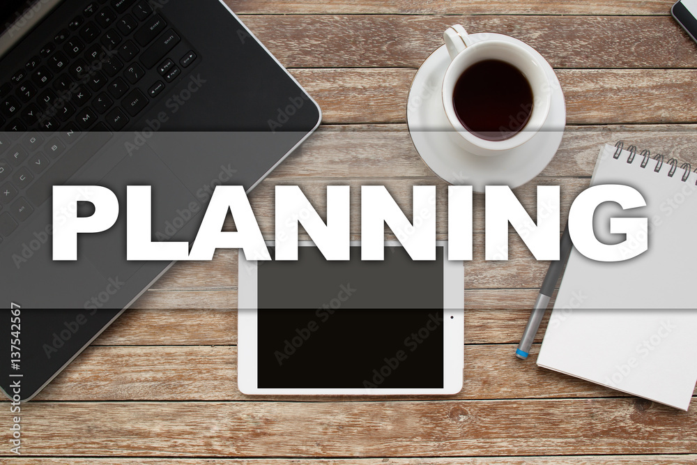 Tablet on desktop with planning text. Tablet on desktop with planning text.