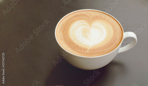 Vintage latte art coffee. Heart shape latter art in white cup