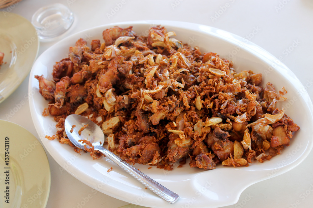 Fried chicken in pieces with garlic and onions Fried chicken in pieces with garlic and onions