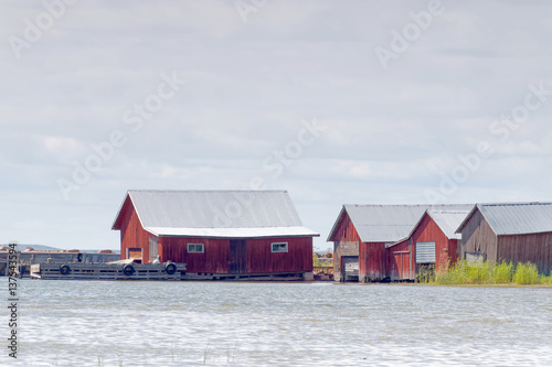 Red boathouses, bridge and sea photo