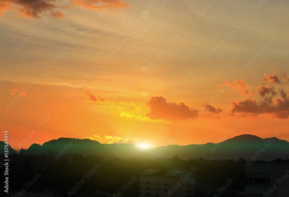 Fototapeta premium sky in sunset and sun reflect cloud variety of color, beautiful colorful multicolored twilight time with mountain silhouette for background