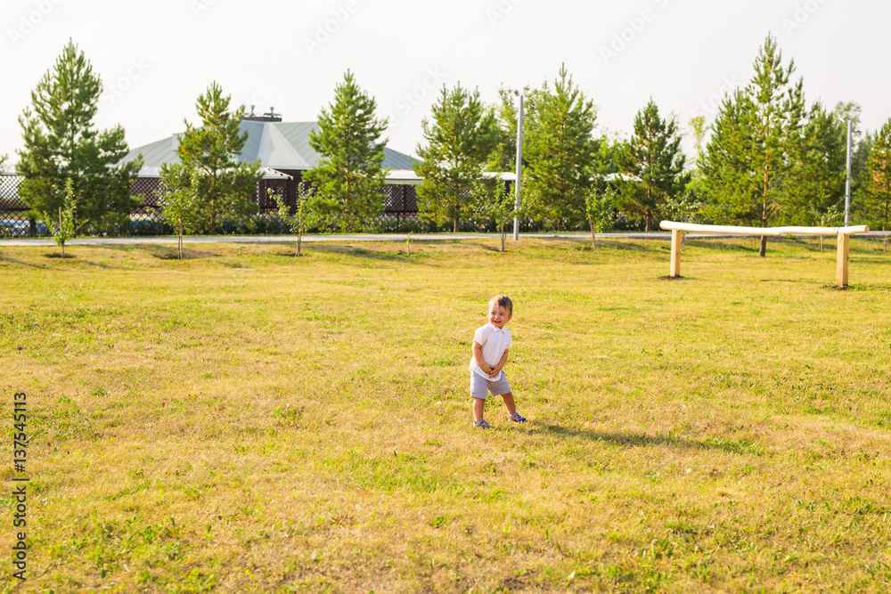 happy child boy with on meadow in summer in nature.