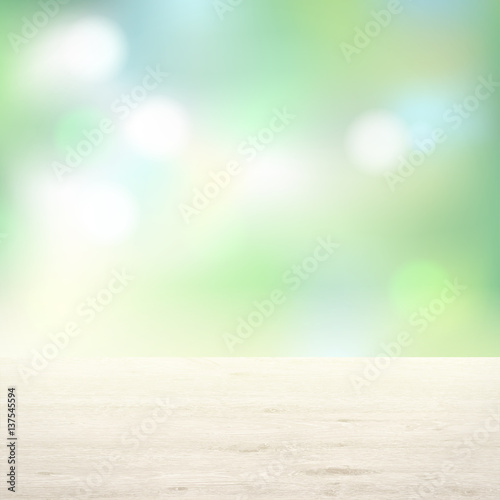 Wooden table on background of trees. Light green background blur.