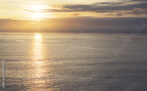 Clouds sky and sunlight sunset on horizon ocean. Silhouette person on background seascape dramatic atmosphere rays sunrise. Relax view waves sea, mockup nature evening concept perspective sunrise © A_B_C