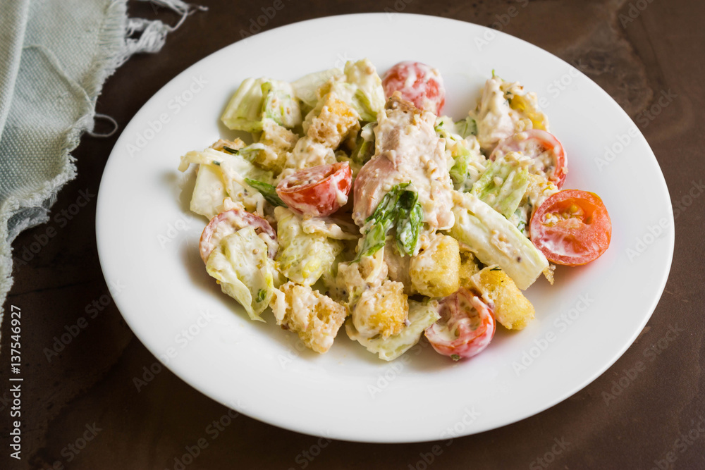Caesar salad with chicken on a marble table Caesar salad with chicken on a marble table