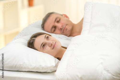 The beautiful couple lay on the bed