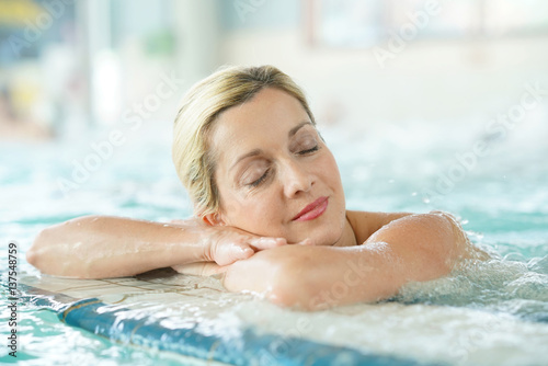 Middle-aged woman enjoying thermal bath in thalassotherapy center