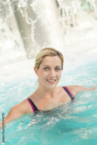 Attractive blond woman relaxing in spa pool