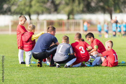 Kids soccer waiting in out with coach © Dusan Kostic