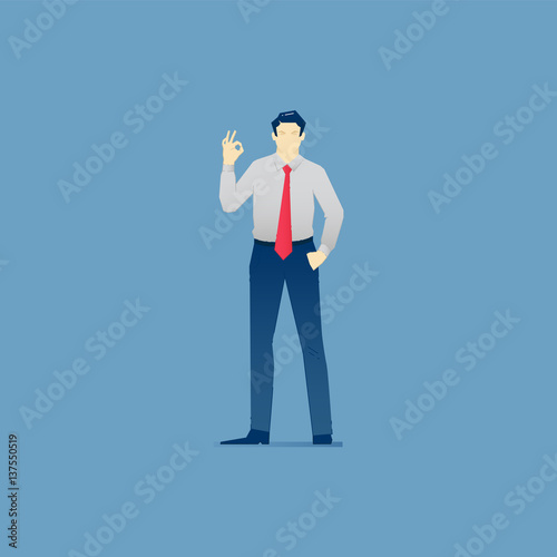 Businessman stands and shows OK gesture