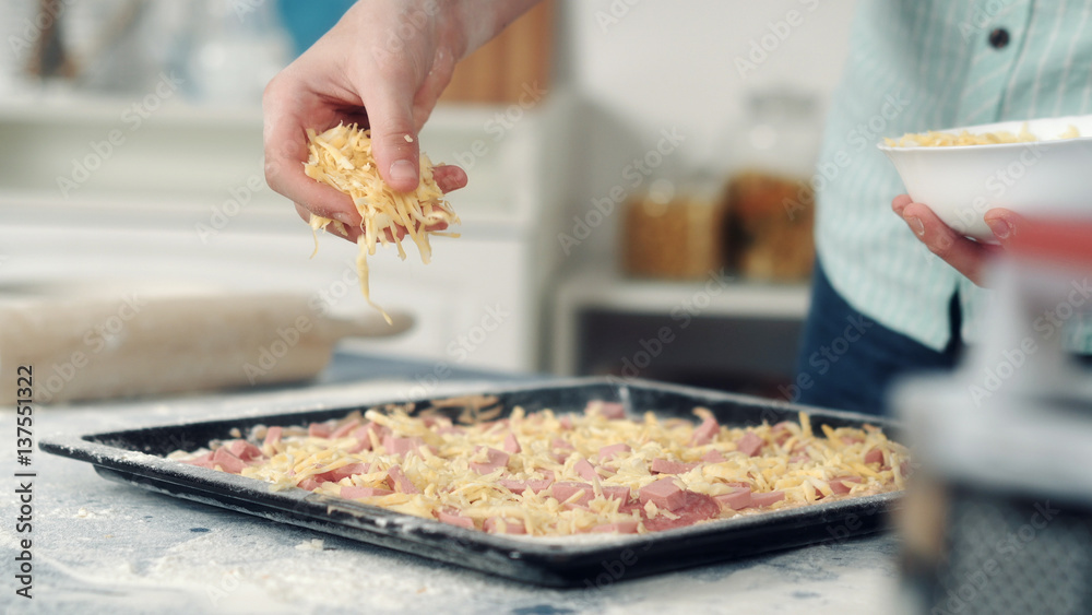 Chef hand sprinkle pizza with cheese
