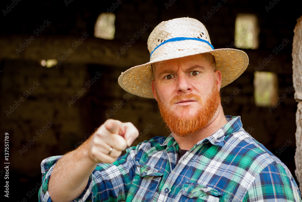 Fototapeta premium Red haired man with a straw hat