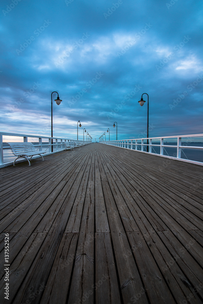 Fototapeta premium Wooden pier in Gdynia Orlowo in the morning with colors of sunrise. Poland. Europe.