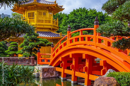Orange bridge to Chinese pagoda in Nan Lian gardens in Hong Kong
