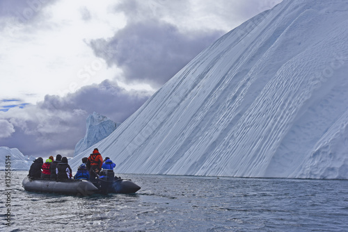 Zodiac tour near enourmous iceberg in the arctic photo