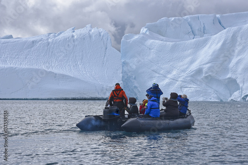 Zodiac tour near enourmous iceberg in the arctic