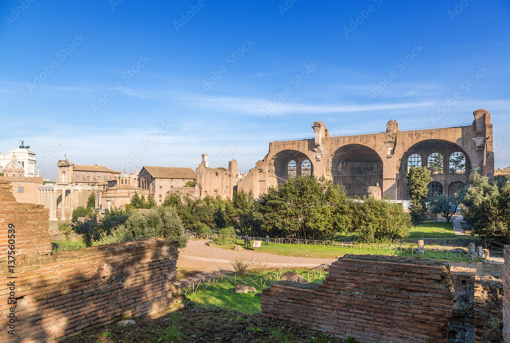 Rome, Italy. Roman Forum, from left to right: Temple of Antoninus and Faustina (141 AD), The temple of Romulus (307 AD), The Basilica of Maxentius and Constantine (312 AD)