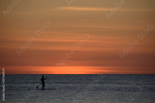 Lonely surfer at sunset over the sea, Boracay Philippines