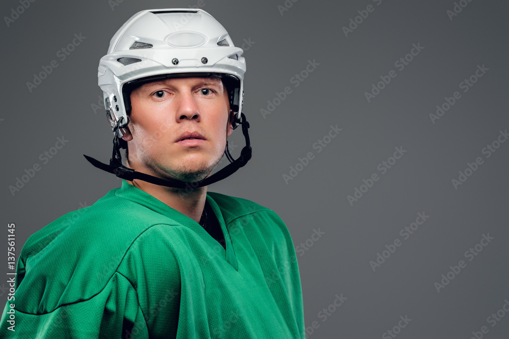 Portrait of hockey player isolated on grey background. Portrait of hockey player isolated on grey background.
