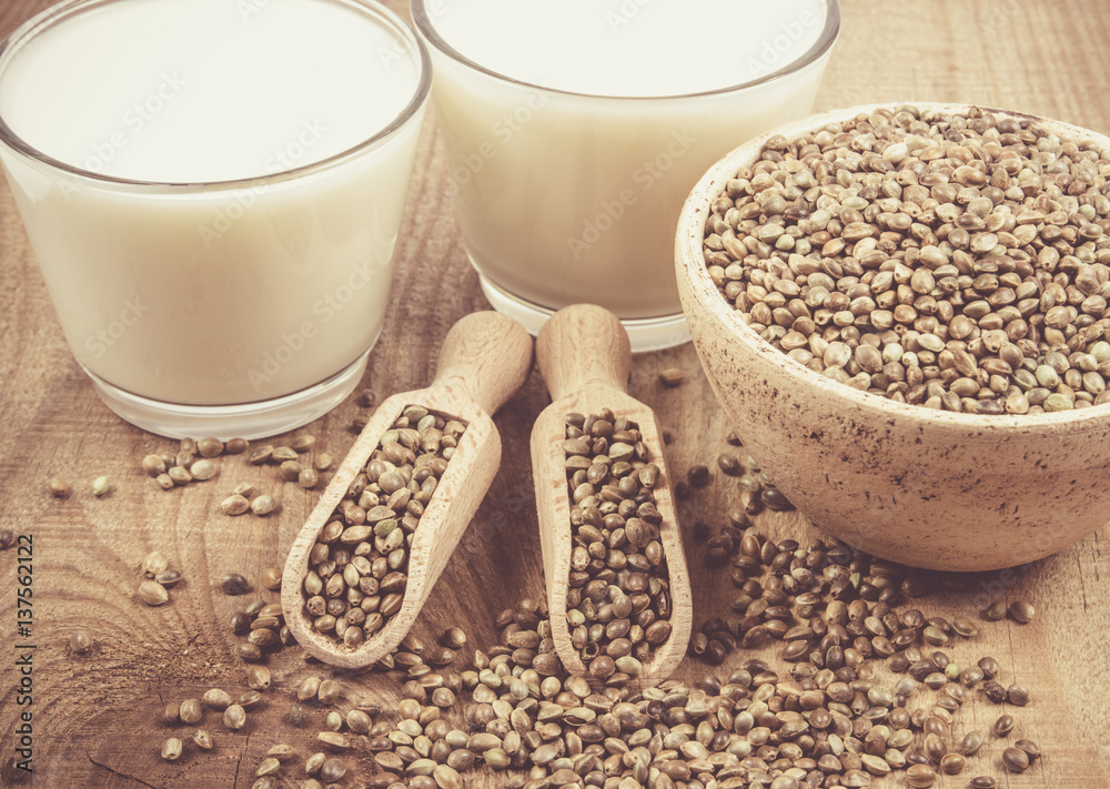 Hemp milk, seeds on wooden background . Close Up . Hemp milk, seeds on wooden background . Close Up .