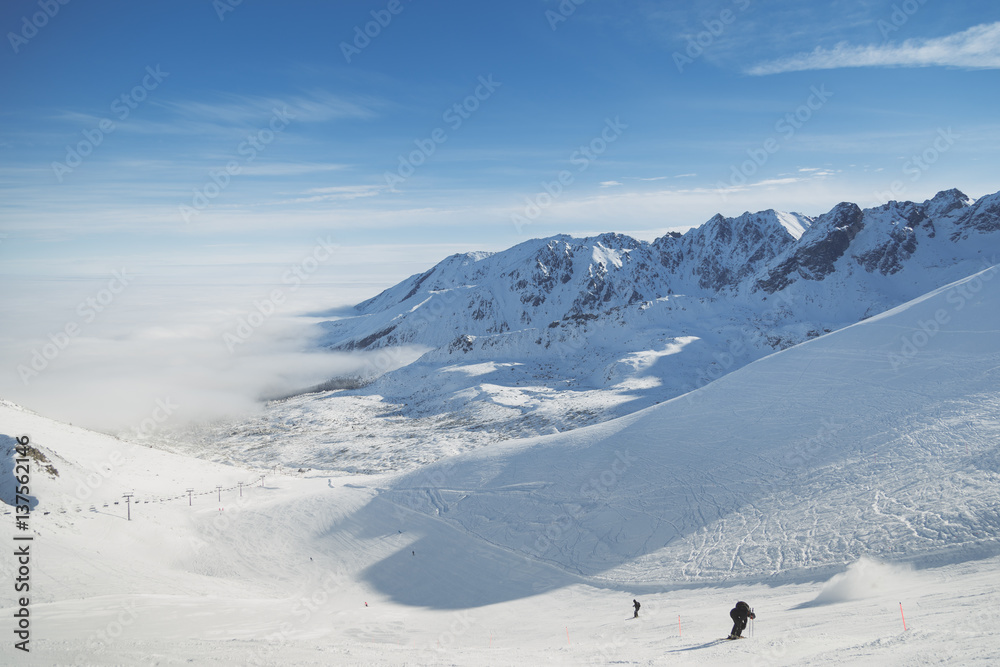 Skiing resorts. Snowy slopes in winter mountains