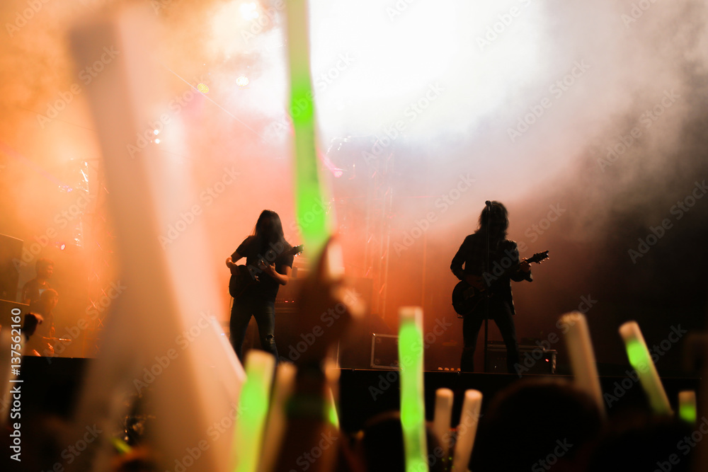 Fototapeta premium Blurred background concert : Bokeh lighting in concert with audience, Music showbiz concept, music performance concert with bokeh spotlight. entertainment concert lighting on stage, blur disco party